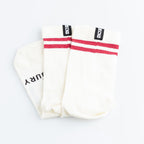Pair of white socks with red stripes on a light gray background