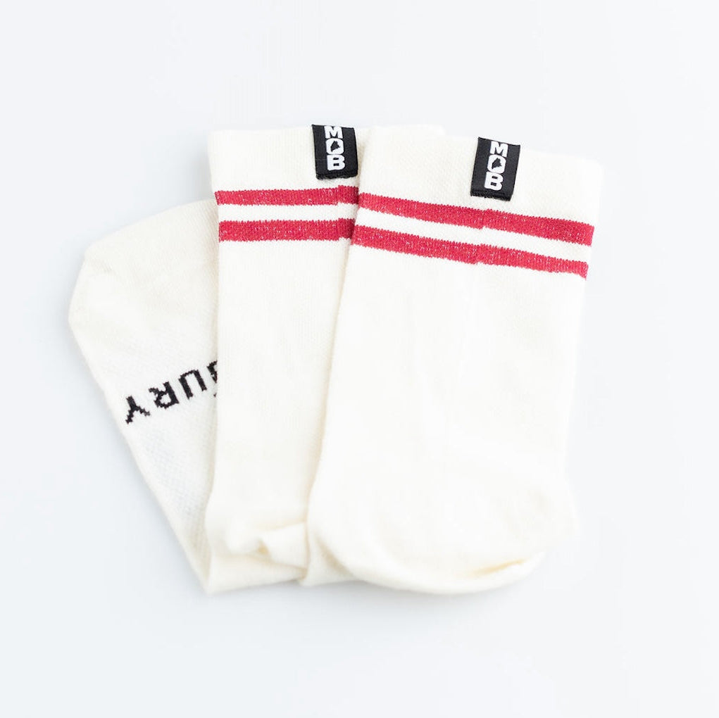 Pair of white socks with red stripes on a light gray background